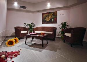 a living room with two chairs and a table at Tus'Hotel in Castel di Tusa