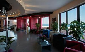 a lobby with potted plants in a building at Tus'Hotel in Castel di Tusa