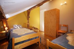 a bedroom with two beds and a tv in it at ferme st martin in Manhay