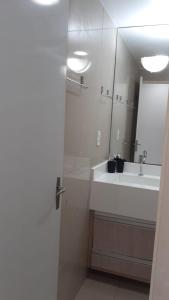 a white bathroom with a sink and a mirror at Victory Flat Intermares in Cabedelo