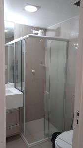 a bathroom with a shower and a toilet and a sink at Victory Flat Intermares in Cabedelo