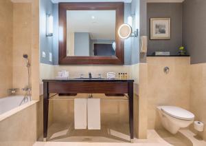 ein Badezimmer mit Waschbecken, Toilette und Spiegel in der Unterkunft InterContinental Warszawa by IHG in Warschau