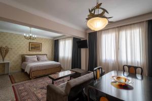 a hotel room with a bed and a dining room at Ririka Athens Homes - Cosy Apartments in Monastiraki, Athens Historical Centre in Athens