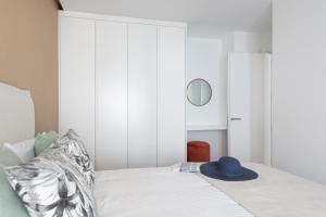 a bedroom with a bed with a hat on it at Royal Flats in Las Palmas de Gran Canaria