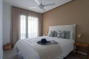 a bedroom with a large bed with a hat on it at Royal Flats in Las Palmas de Gran Canaria