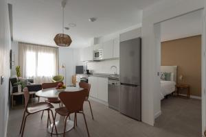 a kitchen and living room with a table and chairs at Royal Flats in Las Palmas de Gran Canaria