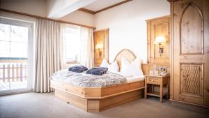a bedroom with a bed with two pillows on it at Anthony´s Alpin Hotel Garni in Lech am Arlberg