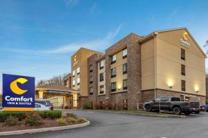 a hotel with a truck parked in front of a building at Comfort Inn & Suites in Pittsburgh