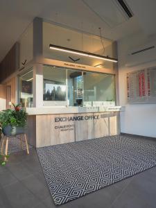 an entrance to an exchange office with a potted plant at CHALEYOTT Mountain Apartments in Harrachov