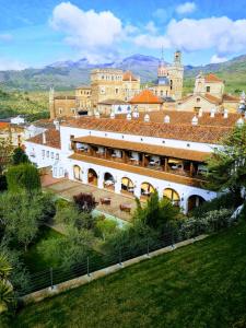 a view of a building with a castle in the background at Parador de Guadalupe in Guadalupe