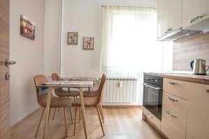 a kitchen with a table and chairs in a room at Elegant & Stylish 2 Bedroom Top Central Apartment in Sofia