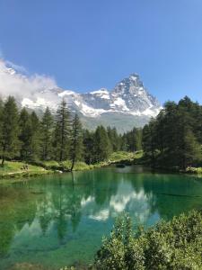a body of water with a mountain in the background at Piccolo paradiso in centro Cervinia in Breuil-Cervinia