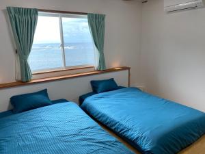 En eller flere senge i et værelse på KR バーズ ヴィラ伊豆白浜リゾート