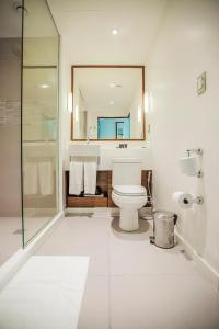 a bathroom with a toilet, sink, and bathtub at Bugan Recife Hotel by Atlantica in Recife