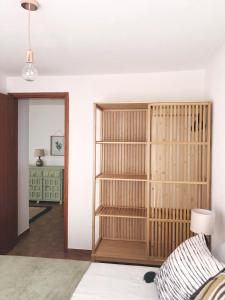 a room with a book shelf and a bedroom at Casa Alejandro Las Vistas in Arona