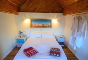 una camera con un letto con due cuscini sopra di Le Petit Chalet-Leard a Jarrier