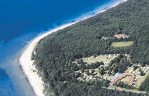 - une vue aérienne sur une maison située sur une colline à côté de l'océan dans l'établissement Nordskoven Strand Camping, à Rønne