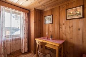 a wooden room with a wooden table and a window at Appartamento primo piano in San Martino in Badia