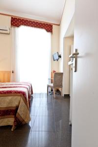 a bedroom with a bed and a sliding door at B&B MediNaples in Naples