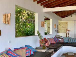 a living room with couches and a large window at Mundo Nuevo Eco Lodge in Minca