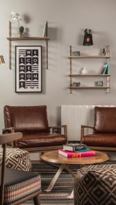 a living room with leather couches and a table at Staybridge Suites Newcastle, an IHG Hotel in Newcastle upon Tyne