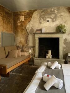 a living room with a bed and a fireplace at Ca' Spontoi, Do-Minus Design Retreat & SPA in Bellinzona