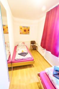 a room with two beds and a chair in it at Golden River in Unterseen