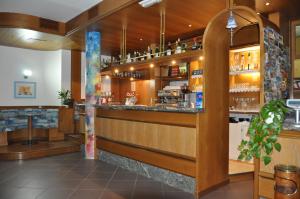 a bar in a restaurant with a counter at Hotel Europa Cembra in Cembra