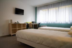 Postel nebo postele na pokoji v ubytování PARME ETAPE