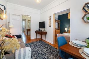 a living room with a bed and a dining room at WHome | Estrela Family Apartment perfect for Families & Friends in Lisbon