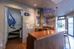 a kitchen with a counter and a bar in a room at Seiki Kyoto Station in Kyoto