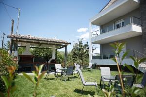 a yard with chairs and a piano in front of a house at Casa Domenica in Stavros