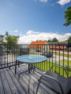 a table and chairs on a deck with a playground at Laimes kopa Pervalka in Pervalka