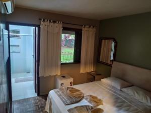 Cama ou camas em um quarto em Pousada Falls Park