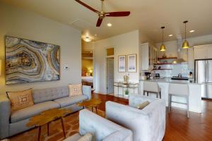a living room with a couch and a kitchen at 563 King Apartments in Charleston