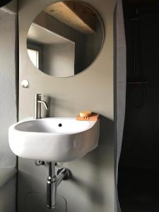 a bathroom with a white sink and a mirror at Ca' Spontoi, Do-Minus Design Retreat & SPA in Bellinzona