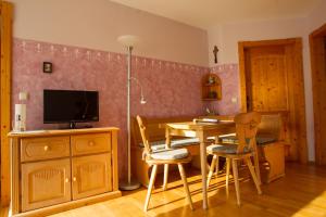 a kitchen with a table and chairs and a television at Naturlaub.pur in Waldmünchen