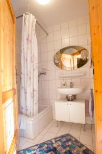 a bathroom with a tub and a sink and a shower at Naturlaub.pur in Waldmünchen +30 photos