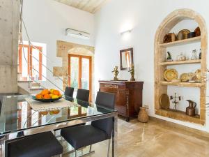 a dining room with a glass table and chairs at Town House Esglesia in Alcudia in Alcudia