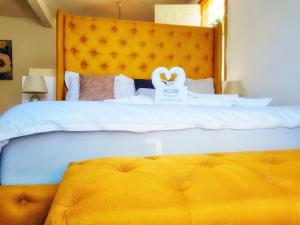 a bedroom with a bed with two swans on it at TIBERIAS by luxury Atitlan in San Pedro La Laguna
