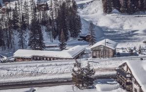 a train station covered in snow next to a mountain at RinerLodge in Davos