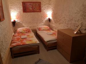 a small room with two beds and a night stand at privatno117 in Lúčky