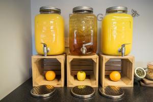 three jars of orange juice and lemons on wooden crates at Holiday Inn Manchester West, an IHG Hotel in Manchester