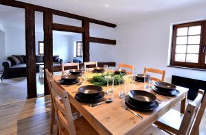 a wooden dining room table with bowls and plates on it at My Riquewihr in Riquewihr