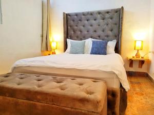 a bedroom with a large bed with a tufted headboard at VENICE by luxury Atitlan in San Pedro La Laguna