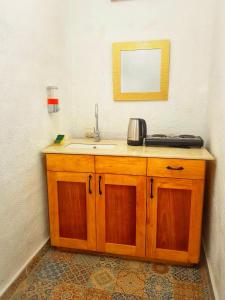 a bathroom counter with a sink and a mirror at VENICE by luxury Atitlan in San Pedro La Laguna