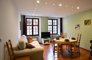 a living room with a couch and a table at My Riquewihr in Riquewihr