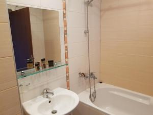 a bathroom with a sink and a shower and a tub at Borovets Gardens Apartments TMF in Borovets