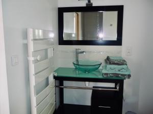 a bathroom with a sink and a mirror at La Miellerie in Lannion