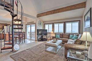 a living room with a couch and a table at 1 Mi to Shops and Dining Idyllic Lakeside Getaway! in Osage Beach